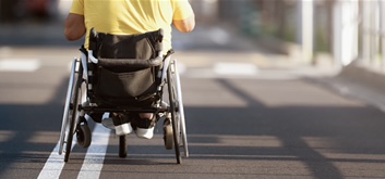 A Man in a Manual Wheelchair Wheelchair on a Street